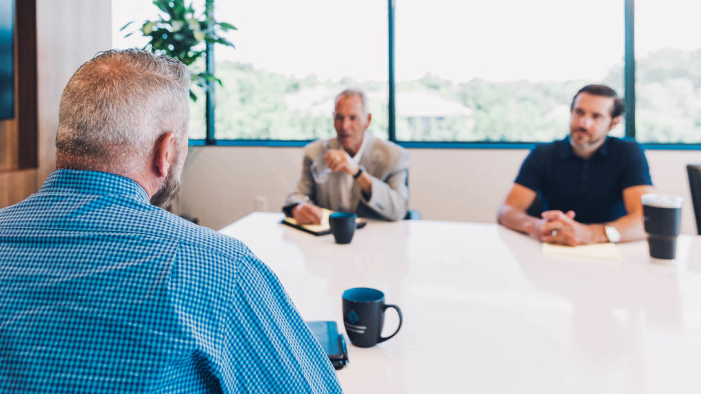 Attorneys Jim Bartimus and Mike Meyer discuss truck accident litigation in Kansas City with a potential client.