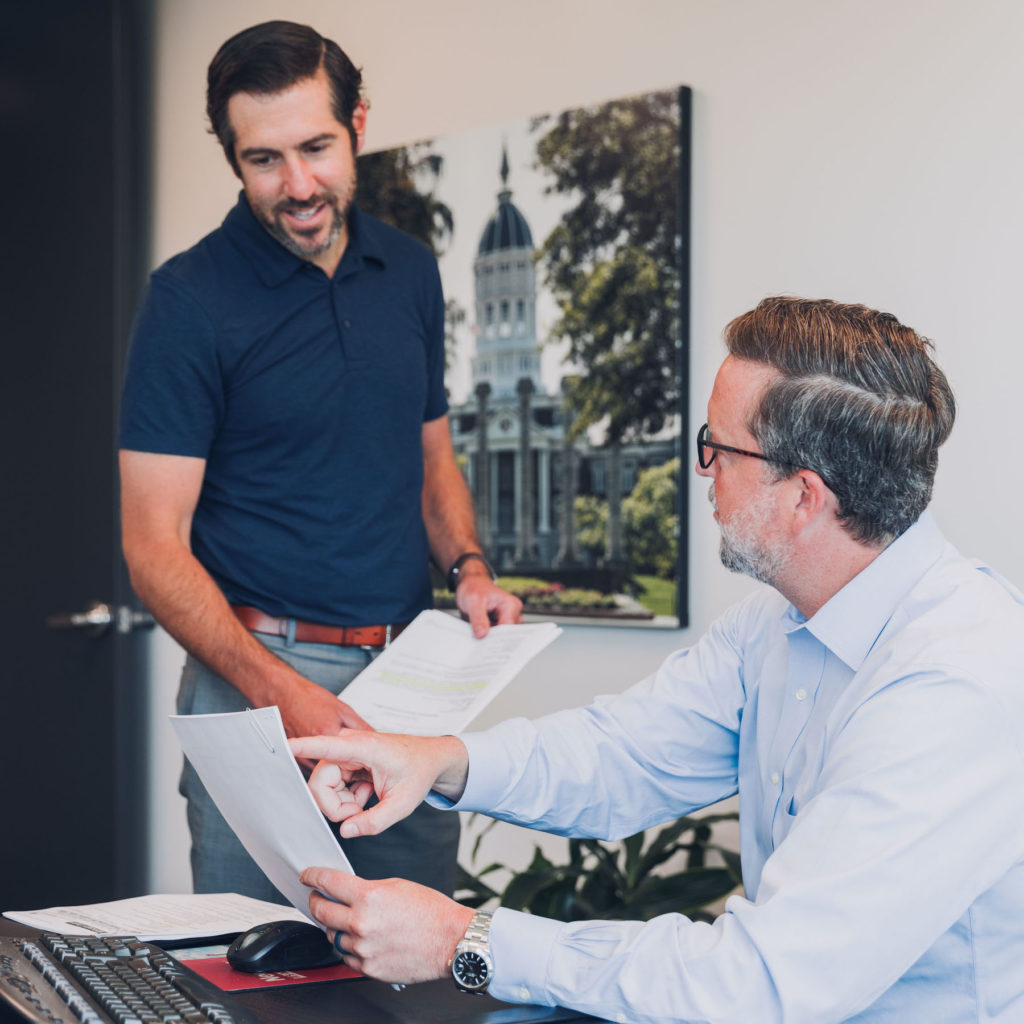 Attorneys Mike Rader and Mike Meyer review paperwork for their truck accident litigation in Kansas City case.