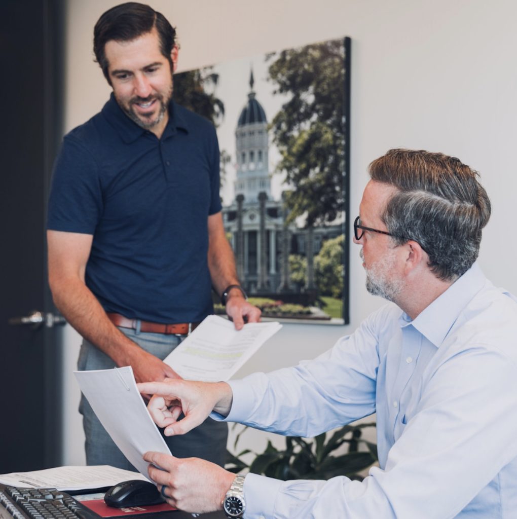 Attorneys Mike Rader and Mike Meyer review paperwork for an upcoming case at our medical malpractice law firm in Overland Park.