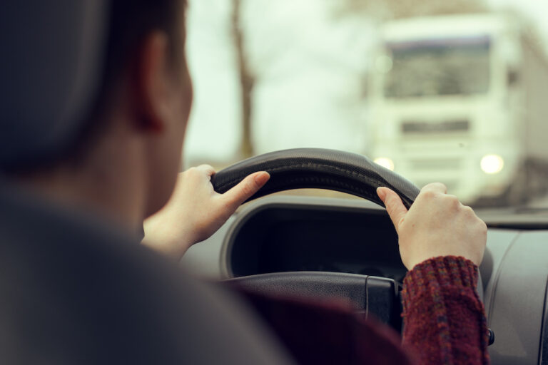 Woman driving car after a truck accident lawsuit in Kansas City.