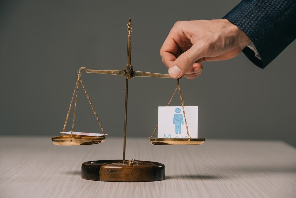 A lawyer handles a scale with a drawing of a male figure to answer the question ""What is bad faith litigation?"