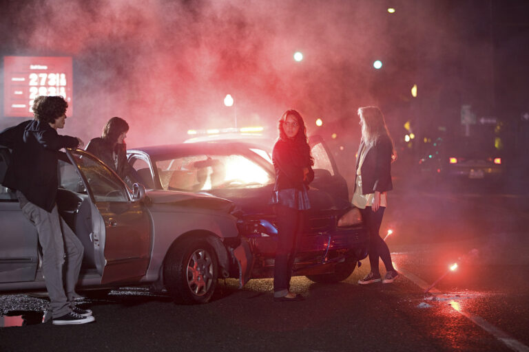 Group of people standing around cars after a Lyft collision, needing a Lyft accident attorney in Kansas City